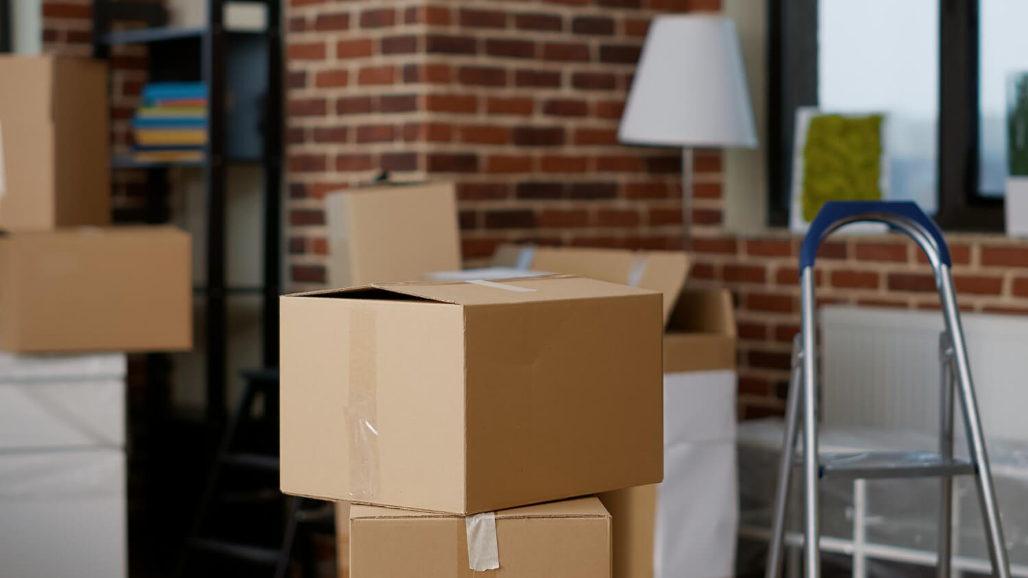 stacks cardboard boxes in empty real estate property with-furniture lamp interior decor