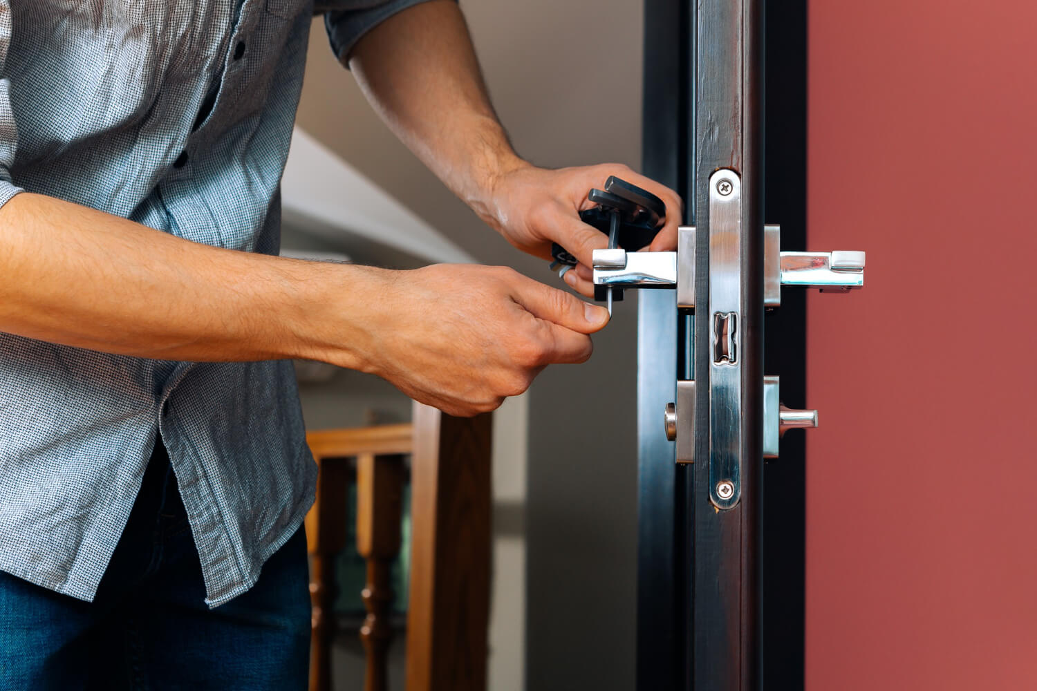 handyman repairing doorknob close up of workers hands installing new locker