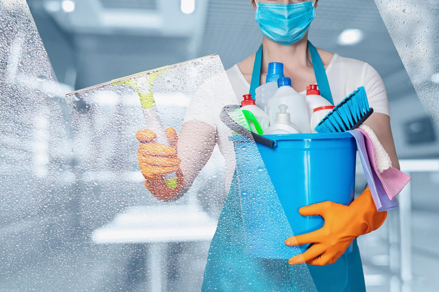 cropped woman close up in proective mask orange protective gloves and blue uniform holding blue bucket with cleaning supplies and cleaning window with wipper