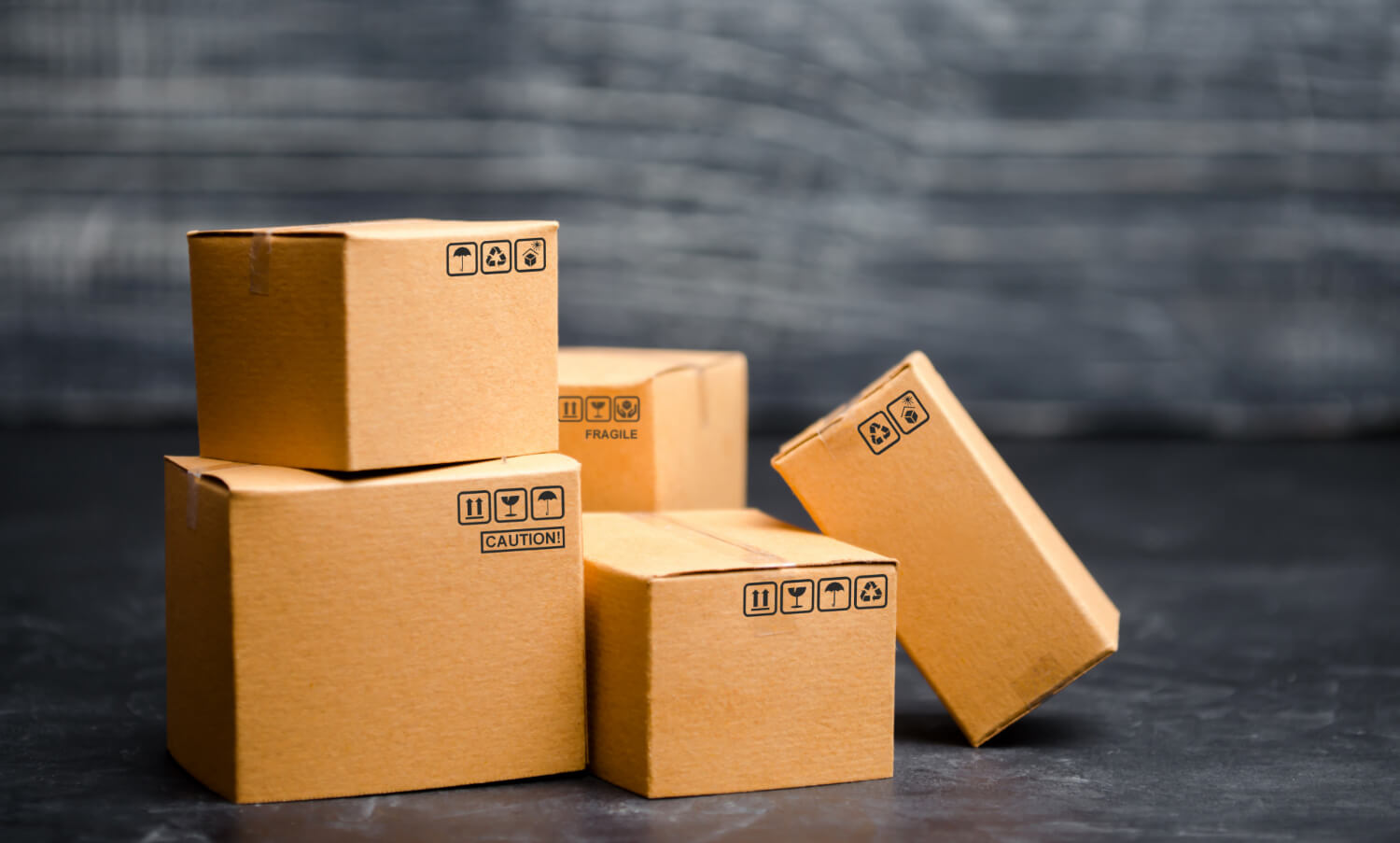 cardboard staffed moving boxes with black backround