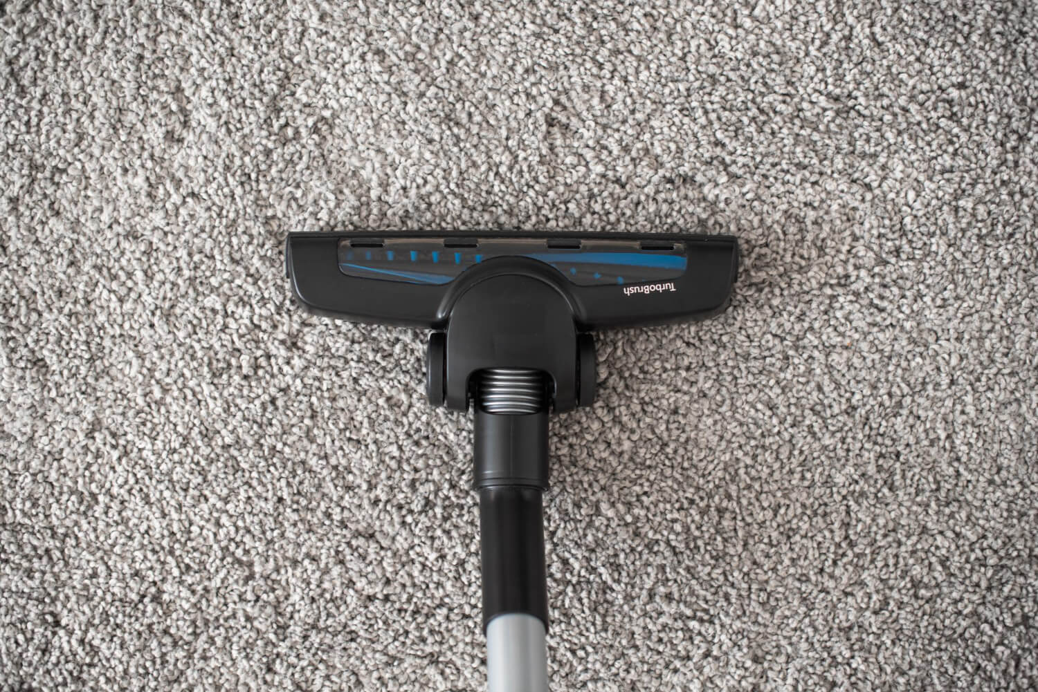 close up head of vacuum cleaner on carpet top view