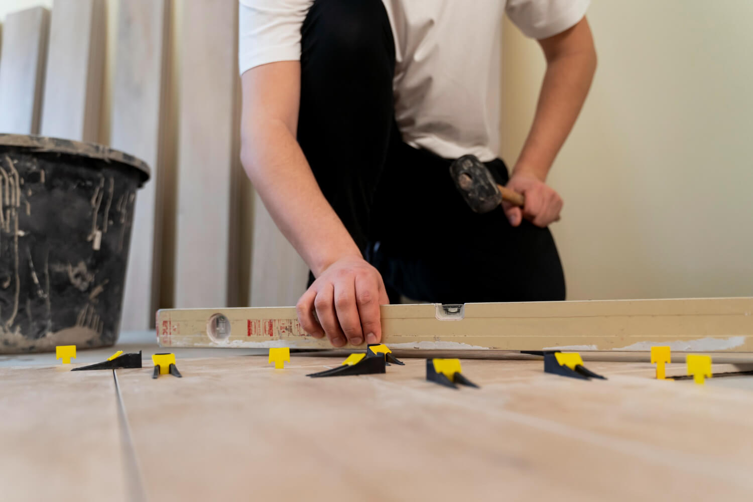 low angle handyman tilling wooden floor