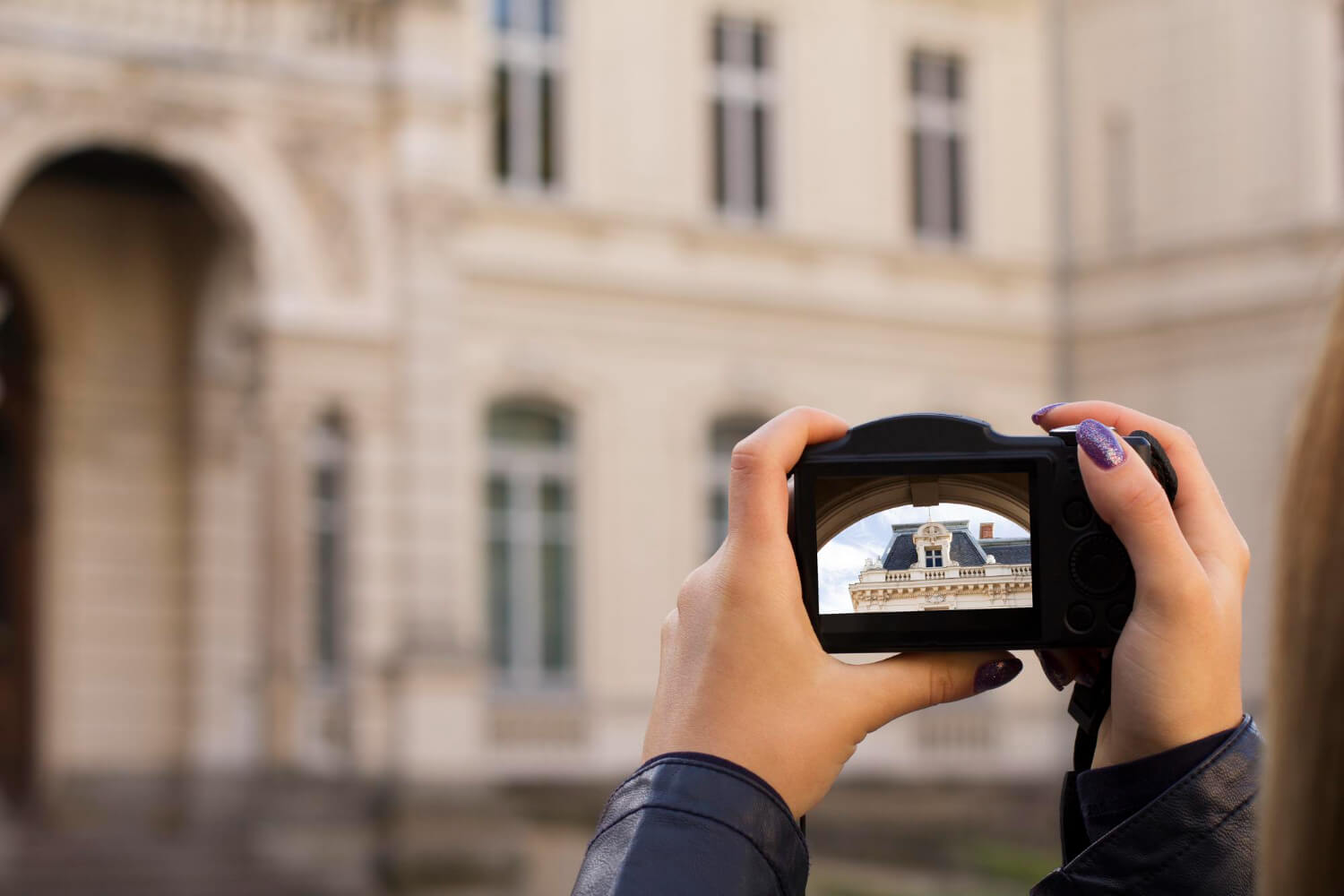 woman holds camera that shows property