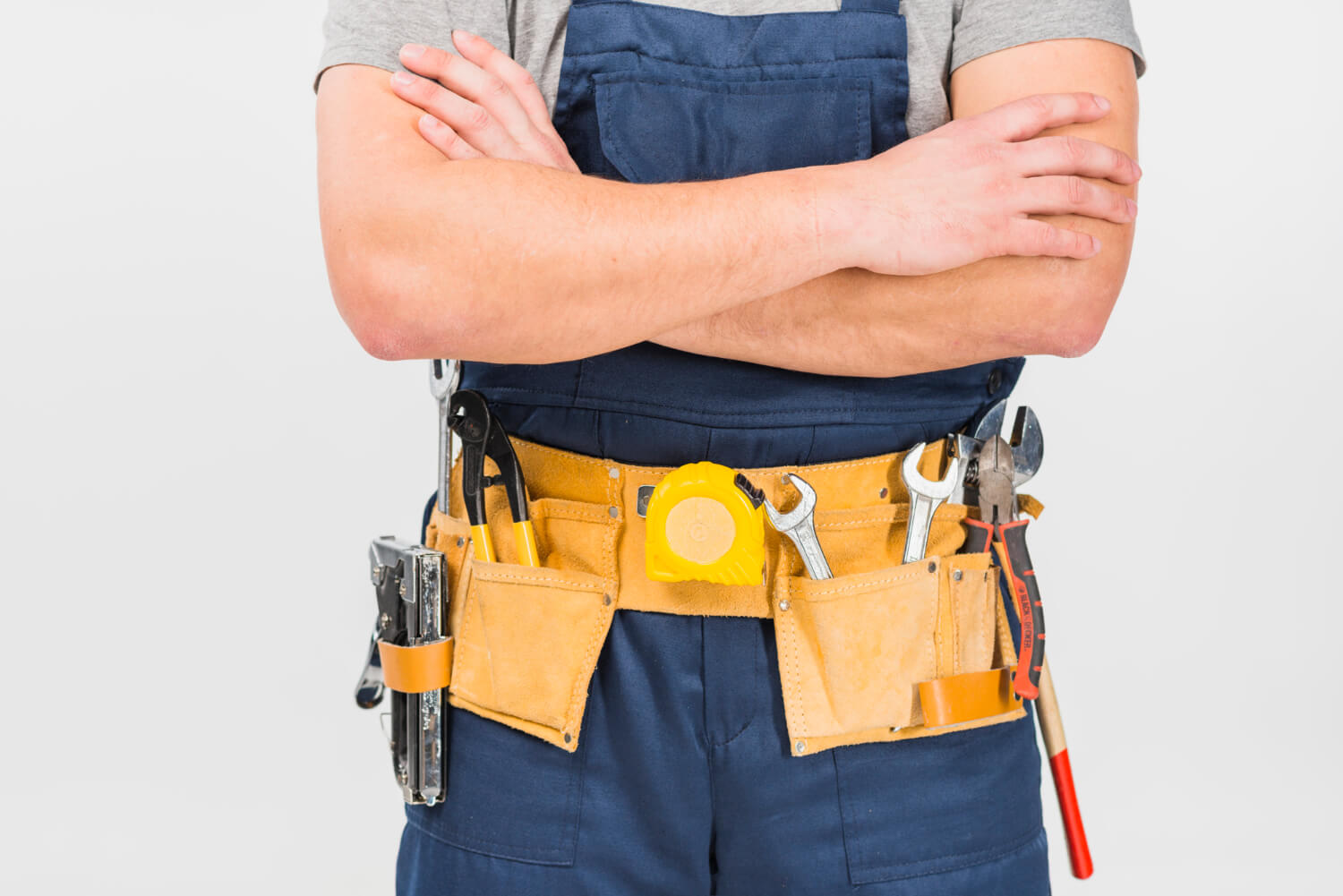 cropped handyman with his arms crossed wearing blue uniform
