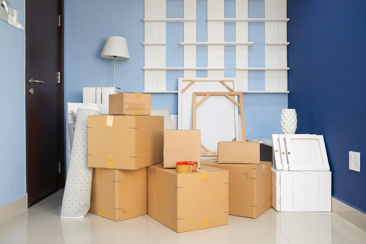 room with blue walls and staffed moving boxes and other home belongings for relocation