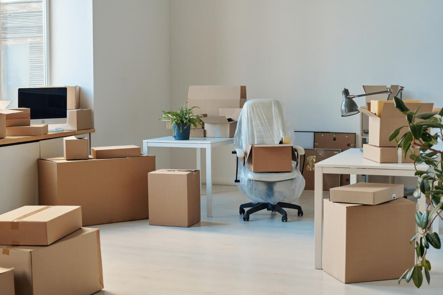 moving boxes and wrapped furniture for moving out of office