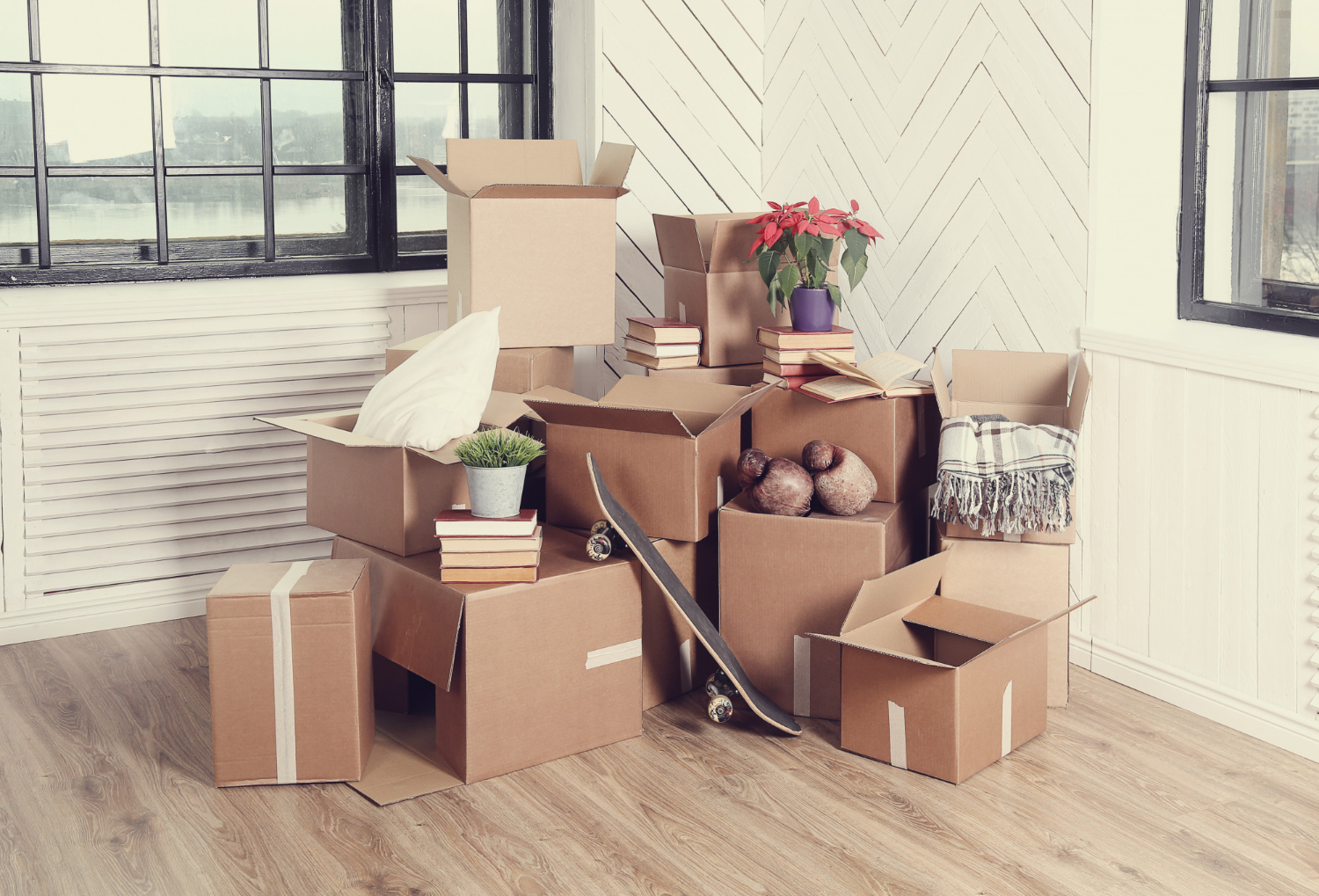 moving boxes and other home belongings stuffed in the corner of living room