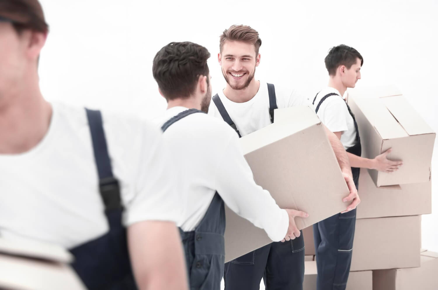 movers pass each other moving boxes in a flat