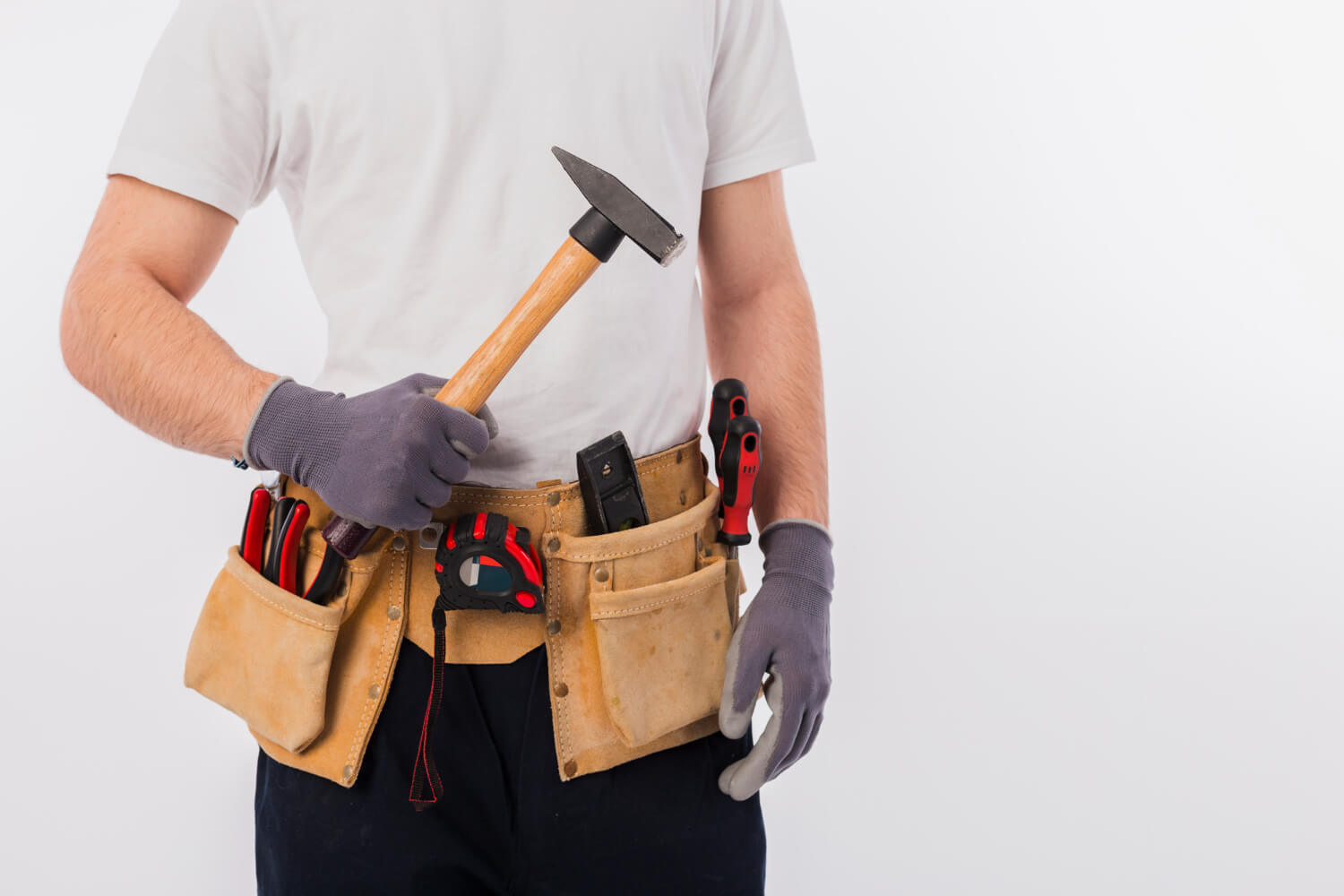 handyman cropped with white tshirt and tool belt holding hammer
