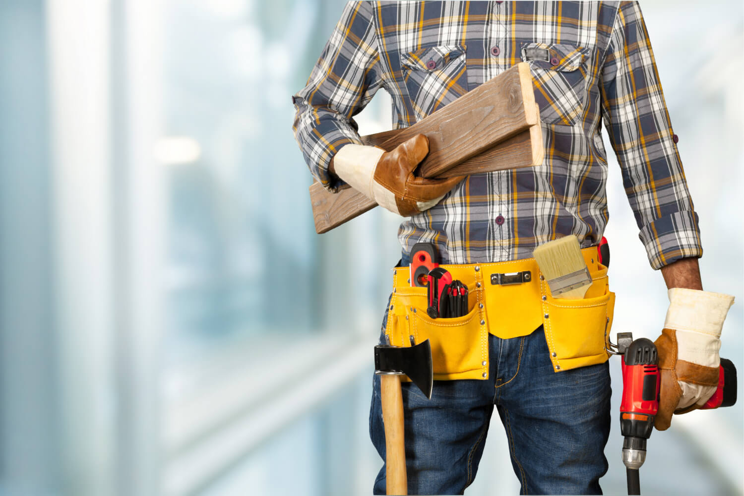 croped view of handyman with belt with tools holding drill and wooden floor pieces