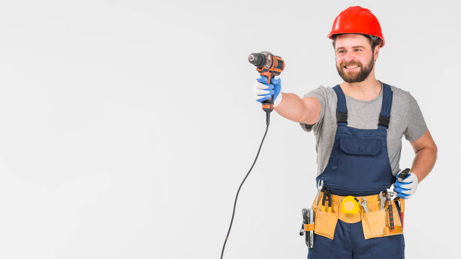 happy handyman smiling while pointing drill on his hand