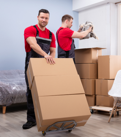 two movers packing and moving boxes for man with a van services